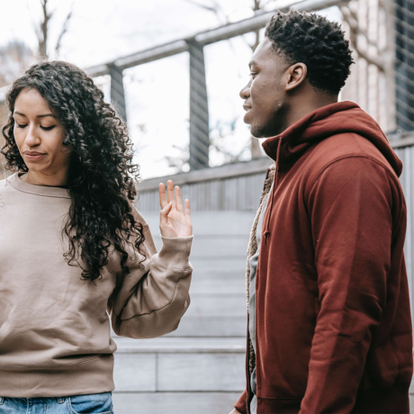 couple arguing on the side of the street