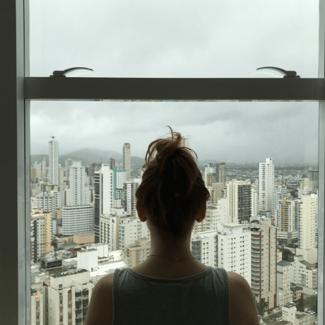 Woman suffering from major depressive disorder looking out a window