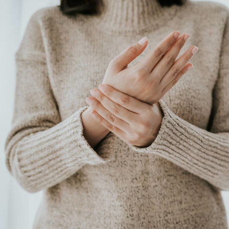 woman holding her hands together over he chest